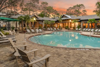 lounge chairs surround resort-style swimming pool at The Lodge at Hidden River