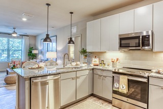 model kitchen in open concept apartment with bright lighting