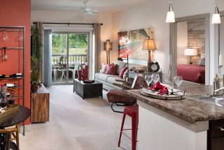 brightly lit and spacious apartment interior with access to private patio