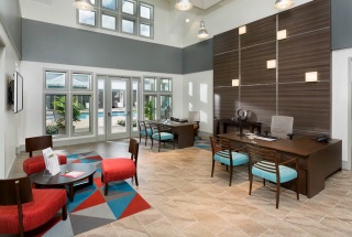 well lit interior of leasing office with high ceiling
