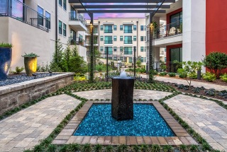 water fountain feature in the middle of spacious courtyard