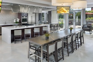 clubroom with kitchen with stylized lighting and overhead televisions