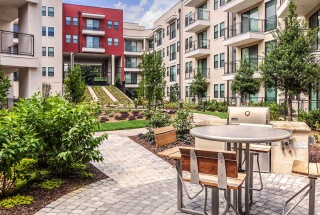 outdoor grill area with table and chairs