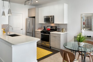 track lighting in galley kitchen open to living room